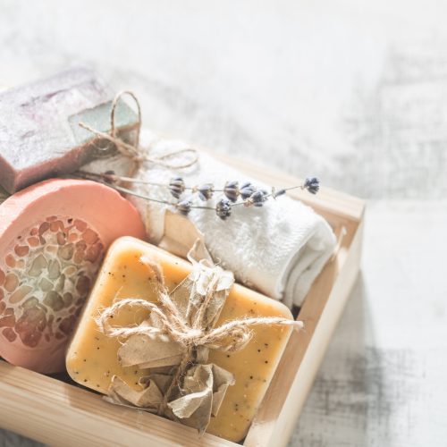 Natural soap Spa set in wooden box place for text on white background, concept of body care and healing